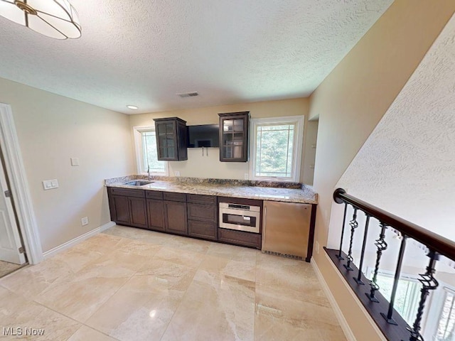 2474 Ginger Wren Rd, Pepper Pike, OH 44124 - kitchen with a textured ceiling, fridge, glass insert cabinets, healthy amount of natural light, and oven