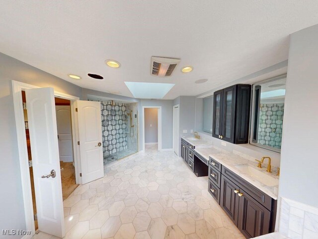 2474 Ginger Wren Rd, Pepper Pike, OH 44124 - bathroom featuring a shower stall, double vanity, recessed lighting, a skylight, and tile patterned flooring