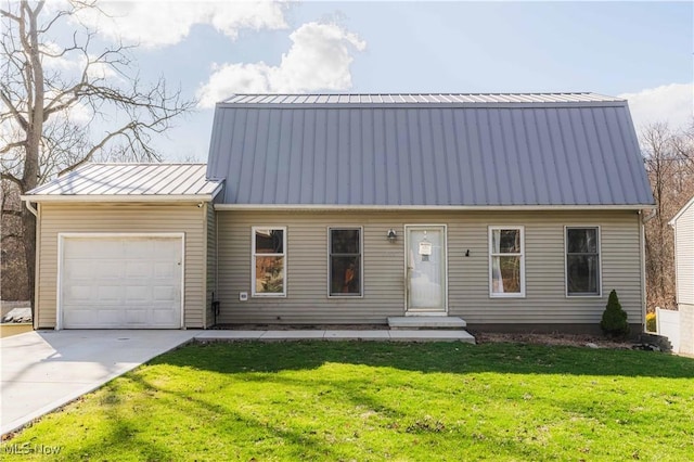 1582 Hilda Ave, Lakemore, OH 44250 - view of front of house with an attached garage, a front yard, concrete driveway, and a metal roof