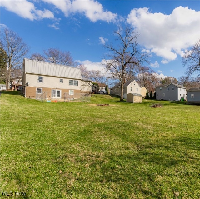 1582 Hilda Ave, Lakemore, OH 44250 - view of grassy yard featuring a storage shed