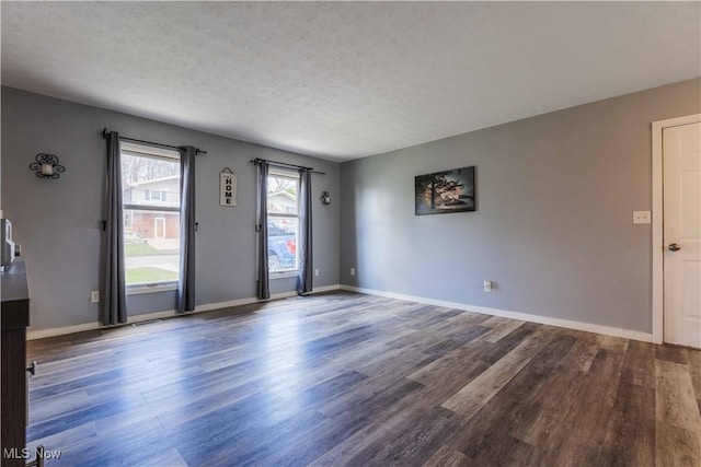 1582 Hilda Ave, Lakemore, OH 44250 - unfurnished living room with wood finished floors and a textured ceiling