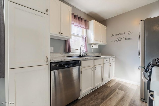 1582 Hilda Ave, Lakemore, OH 44250 - kitchen with dishwasher, wood finished floors, white cabinets, and stove