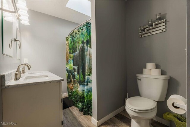 1582 Hilda Ave, Lakemore, OH 44250 - bathroom featuring wood finished floors and vanity