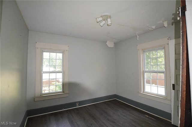 664 N Ellsworth Ave, Salem, OH 44460 - empty room with plenty of natural light and dark wood-style floors