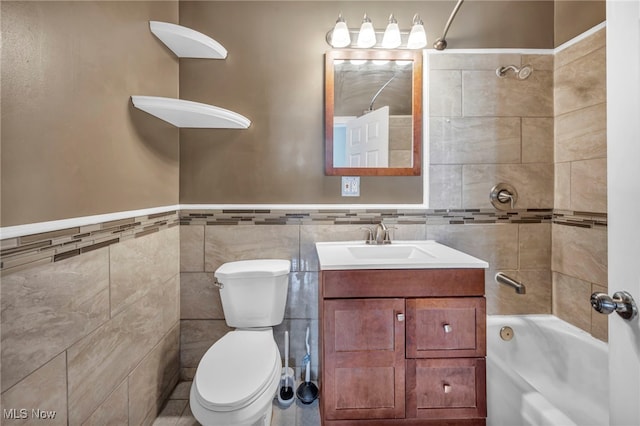 3303 Tuxedo Ave, Parma, OH 44134 - bathroom featuring tile walls, bathtub / shower combination, vanity, and wainscoting