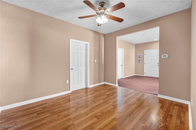 3303 Tuxedo Ave, Parma, OH 44134 - unfurnished room featuring light wood-type flooring, ceiling fan, and a textured ceiling