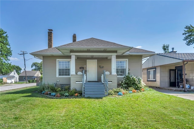 3303 Tuxedo Ave, Parma, OH 44134 - bungalow-style house featuring a front lawn, a chimney, a shingled roof, and a porch