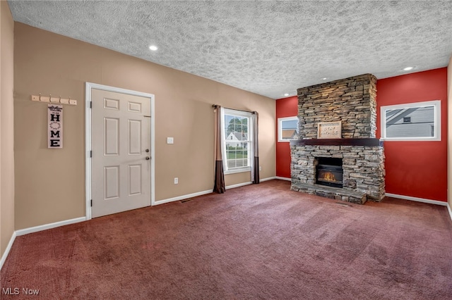 3303 Tuxedo Ave, Parma, OH 44134 - unfurnished living room featuring a textured ceiling, carpet flooring, a stone fireplace, and recessed lighting