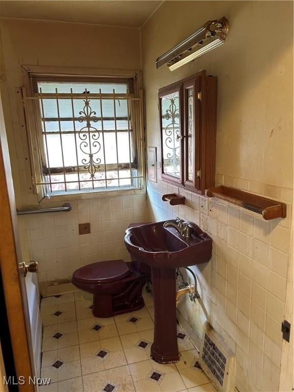 9822 Way Ave, Cleveland, OH 44105 - bathroom featuring tile walls, tile patterned flooring, and wainscoting