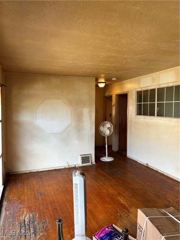 9822 Way Ave, Cleveland, OH 44105 - empty room with wood-type flooring and a textured ceiling
