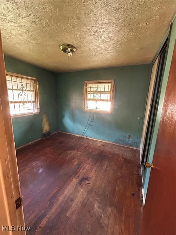 9822 Way Ave, Cleveland, OH 44105 - unfurnished room featuring wood-type flooring and a textured ceiling