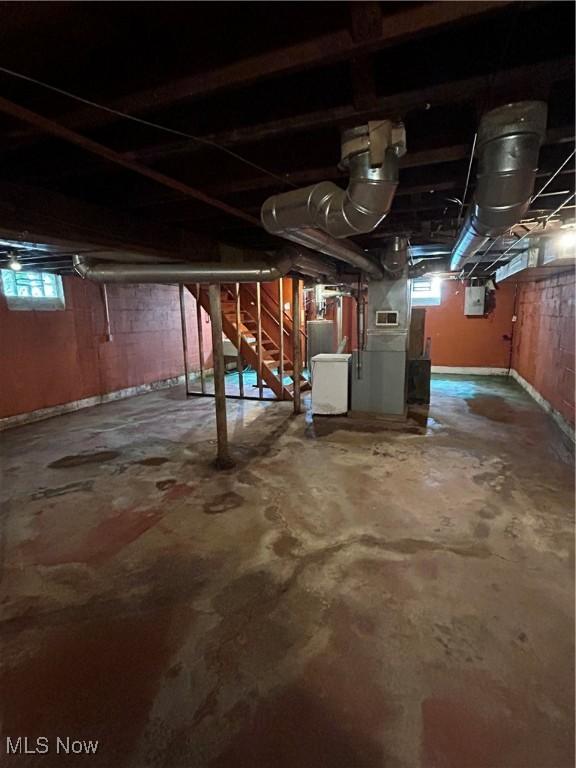 9822 Way Ave, Cleveland, OH 44105 - basement with electric panel, stairway, and water heater