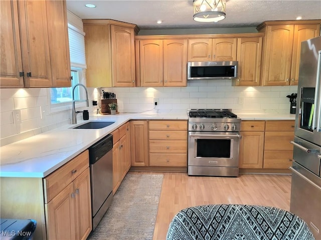 2977 Pirates Cv, Aurora, OH 44202 - kitchen featuring stainless steel appliances, light wood-type flooring, backsplash, light brown cabinets, and recessed lighting