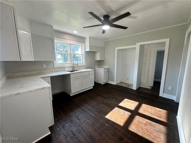 16707 Terrace Ave, Caldwell, OH 43724 - kitchen featuring a ceiling fan, white cabinetry, dark wood-style floors, and light stone counters