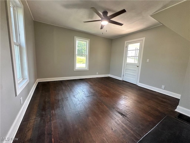 16707 Terrace Ave, Caldwell, OH 43724 - empty room featuring a ceiling fan, healthy amount of natural light, and dark wood-type flooring