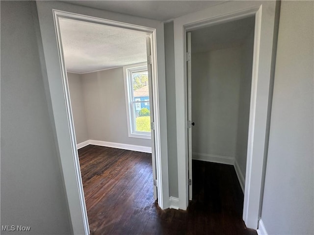 16707 Terrace Ave, Caldwell, OH 43724 - hallway featuring dark wood-style flooring and a textured ceiling