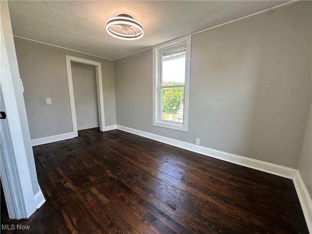 16707 Terrace Ave, Caldwell, OH 43724 - unfurnished room featuring a textured ceiling and dark wood finished floors