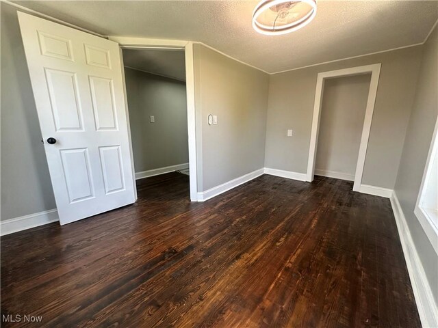 16707 Terrace Ave, Caldwell, OH 43724 - spare room with dark wood finished floors and a textured ceiling