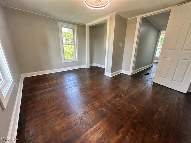 16707 Terrace Ave, Caldwell, OH 43724 - empty room featuring dark wood-type flooring and healthy amount of natural light