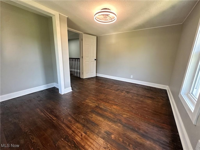 16707 Terrace Ave, Caldwell, OH 43724 - spare room featuring dark wood-style floors and a textured ceiling