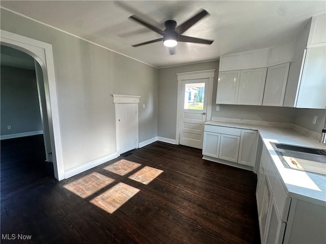 16707 Terrace Ave, Caldwell, OH 43724 - kitchen featuring dark wood-type flooring, light countertops, arched walkways, and ceiling fan
