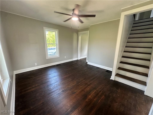 16707 Terrace Ave, Caldwell, OH 43724 - spare room with dark wood-style floors, stairway, a ceiling fan, and arched walkways