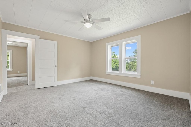 6434 Union Ave NE, Alliance, OH 44601 - carpeted empty room with plenty of natural light, a ceiling fan, and crown molding