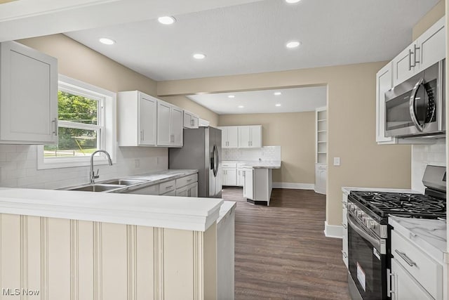 6434 Union Ave NE, Alliance, OH 44601 - kitchen with stainless steel appliances, a peninsula, backsplash, recessed lighting, and dark wood-style floors