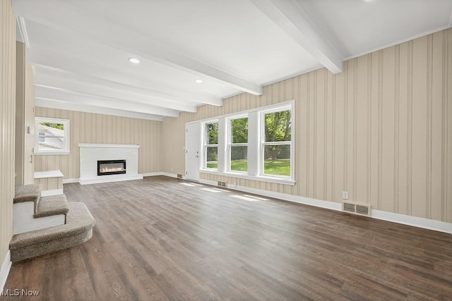 6434 Union Ave NE, Alliance, OH 44601 - unfurnished living room featuring beamed ceiling, wood finished floors, and a glass covered fireplace