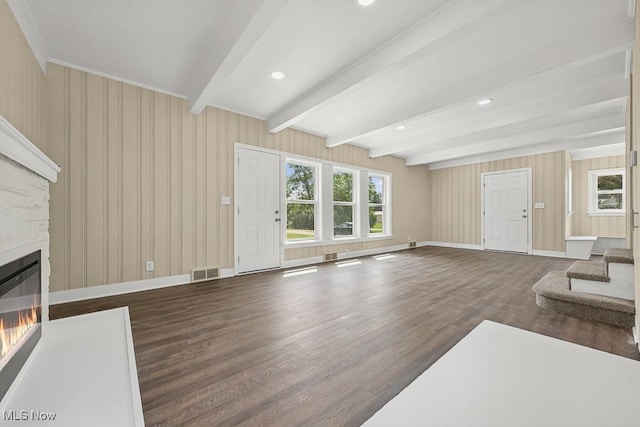 6434 Union Ave NE, Alliance, OH 44601 - unfurnished living room with wood finished floors, beamed ceiling, a glass covered fireplace, stairs, and recessed lighting