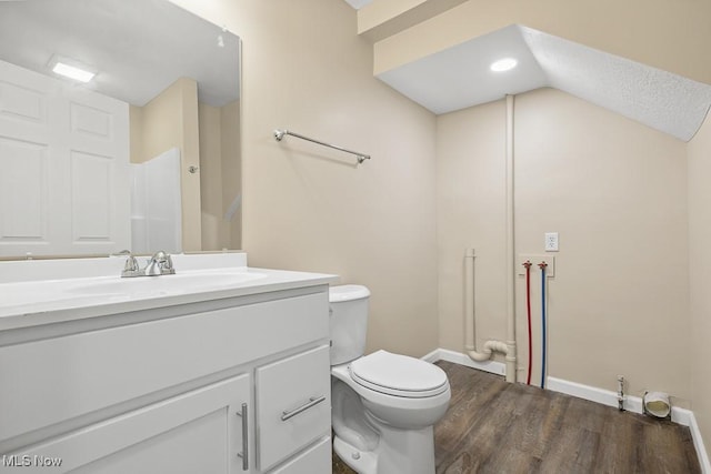 6434 Union Ave NE, Alliance, OH 44601 - bathroom featuring wood finished floors, vanity, and vaulted ceiling