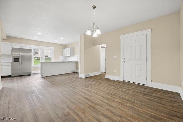 6434 Union Ave NE, Alliance, OH 44601 - unfurnished living room with wood finished floors, a chandelier, and recessed lighting