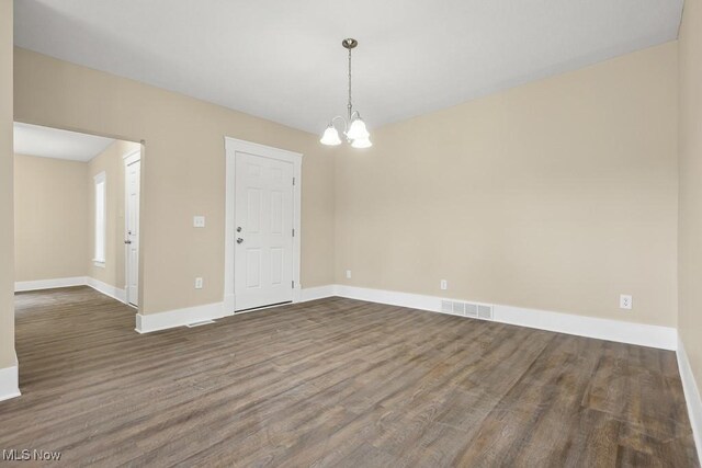 6434 Union Ave NE, Alliance, OH 44601 - empty room featuring a chandelier and dark wood-style floors