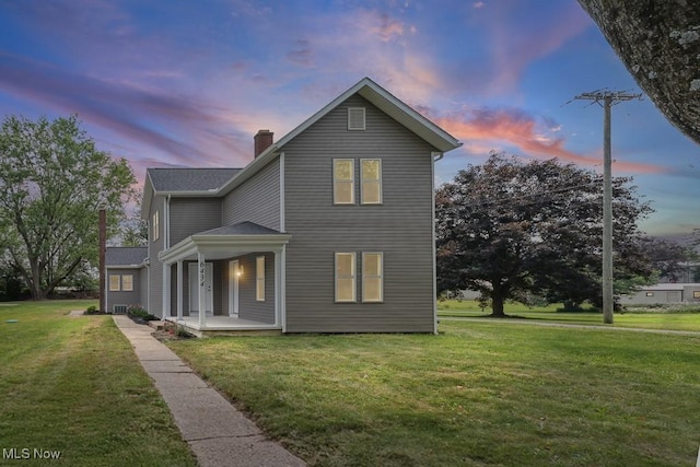 6434 Union Ave NE, Alliance, OH 44601 - view of front facade with a lawn, a chimney, and a porch