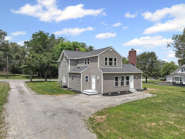 6434 Union Ave NE, Alliance, OH 44601 - view of front of property with a chimney, a shingled roof, a front lawn, and driveway
