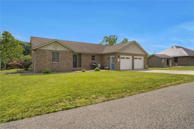 45330 Maple View Cir, Caldwell, OH 43724 - ranch-style home with a garage, brick siding, driveway, and a front lawn