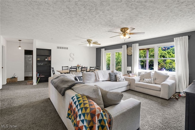 45330 Maple View Cir, Caldwell, OH 43724 - living area with carpet floors, a ceiling fan, and a textured ceiling