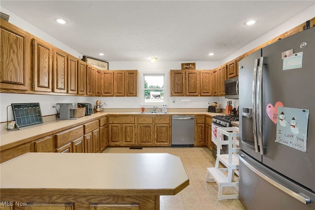 45330 Maple View Cir, Caldwell, OH 43724 - kitchen with stainless steel appliances, brown cabinetry, light countertops, recessed lighting, and a peninsula