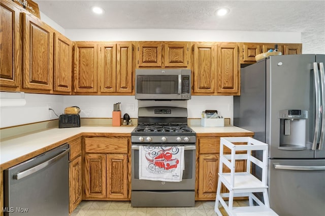 45330 Maple View Cir, Caldwell, OH 43724 - kitchen featuring appliances with stainless steel finishes, light countertops, brown cabinets, and recessed lighting