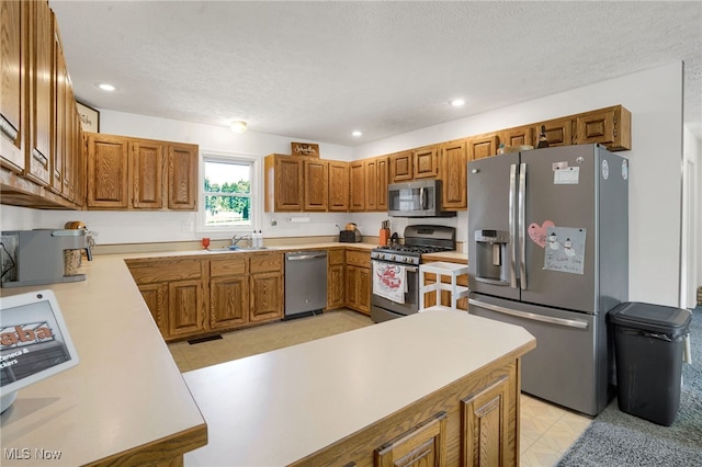 45330 Maple View Cir, Caldwell, OH 43724 - kitchen featuring stainless steel appliances, light countertops, a textured ceiling, brown cabinets, and recessed lighting
