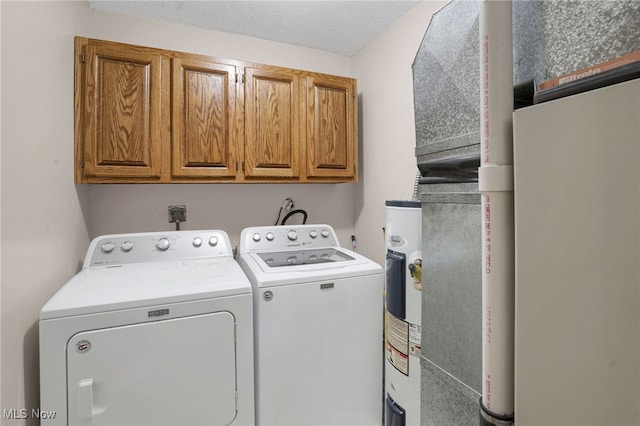 45330 Maple View Cir, Caldwell, OH 43724 - washroom with washing machine and clothes dryer, cabinet space, and water heater