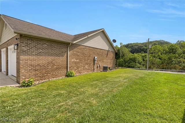 45330 Maple View Cir, Caldwell, OH 43724 - view of side of property featuring brick siding, a garage, and a yard