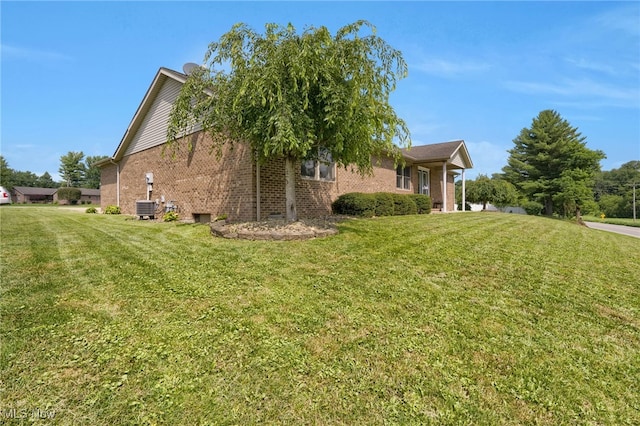 45330 Maple View Cir, Caldwell, OH 43724 - view of home's exterior with brick siding and a lawn