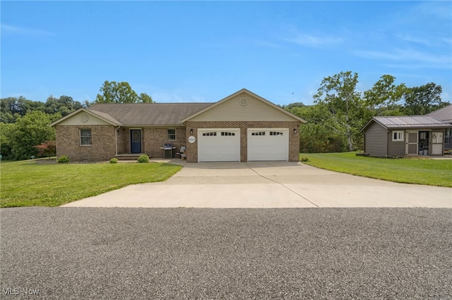 45330 Maple View Cir, Caldwell, OH 43724 - ranch-style home with a garage, brick siding, concrete driveway, and a front lawn