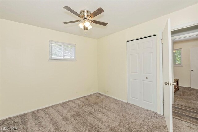 3498 Clayton Dr, North Olmsted, OH 44070 - unfurnished bedroom with carpet floors, ceiling fan, and a closet