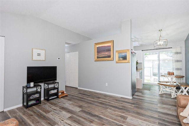 3498 Clayton Dr, North Olmsted, OH 44070 - living room featuring wood finished floors, lofted ceiling, and a chandelier
