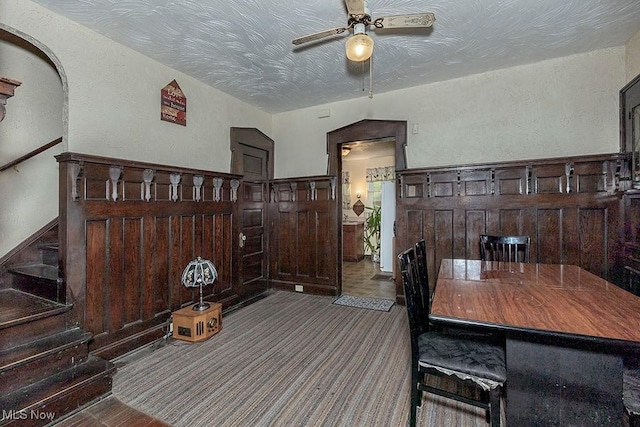 1744 Northfield Ave, East Cleveland, OH 44112 - carpeted dining area with ceiling fan, a textured wall, stairs, and a textured ceiling