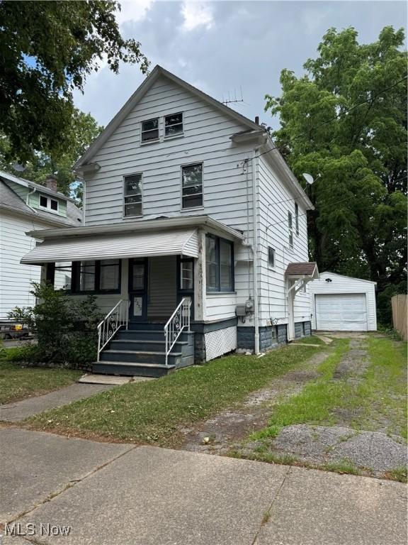 2239 23rd St SW, Akron, OH 44314 - traditional style home featuring a detached garage, driveway, an outdoor structure, and covered porch