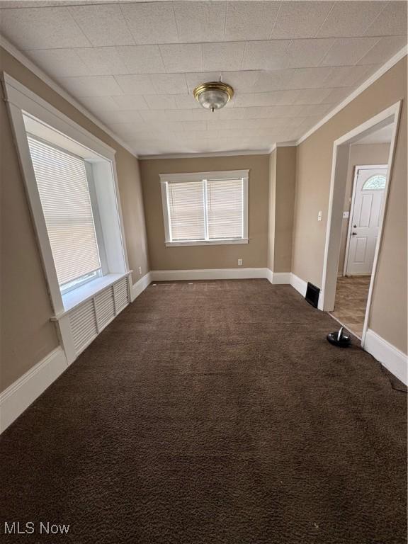 2239 23rd St SW, Akron, OH 44314 - carpeted spare room featuring crown molding