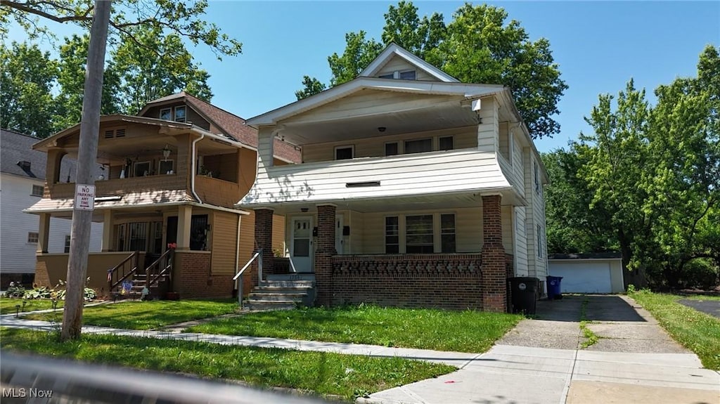 1758 Algonac, Cleveland, OH 44112 - view of front of property with covered porch, a balcony, brick siding, and a garage